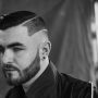 Taglio capelli uomo rasato ai lati con righe e barba Moda Inverno 2017